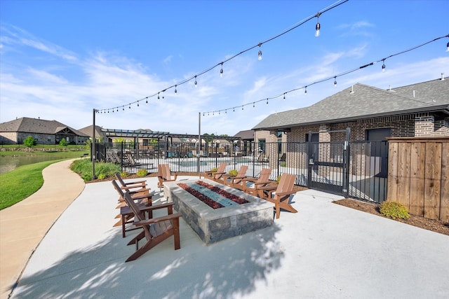 view of patio featuring fence and a fire pit