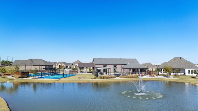 property view of water with a residential view and fence