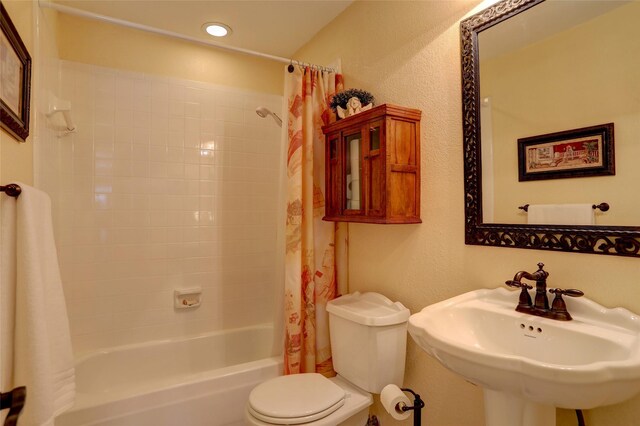 full bathroom with shower / tub combo, toilet, and sink