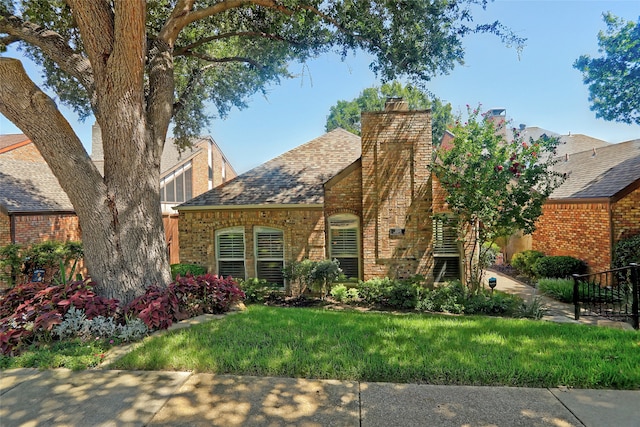 english style home with a front yard