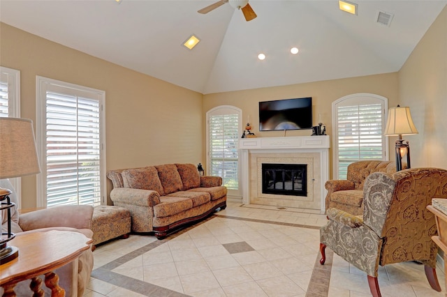 living room featuring plenty of natural light, light tile patterned flooring, and a fireplace