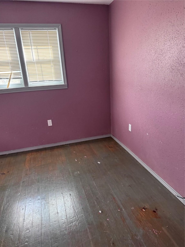 empty room with dark hardwood / wood-style floors