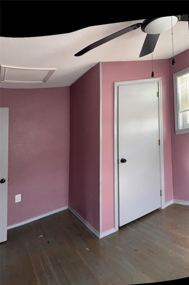 spare room with ceiling fan and dark hardwood / wood-style floors