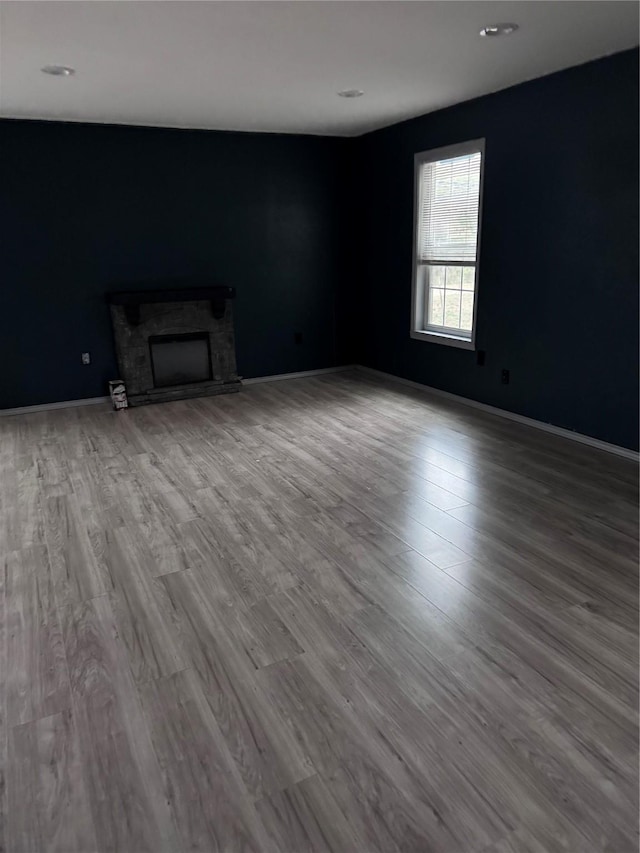 unfurnished living room with a fireplace and hardwood / wood-style floors