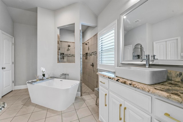 bathroom featuring tile patterned flooring, plus walk in shower, and vanity