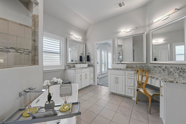 bathroom featuring vanity, vaulted ceiling, and tile patterned floors