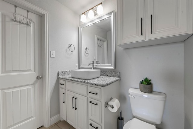 bathroom with vanity, tile patterned floors, and toilet