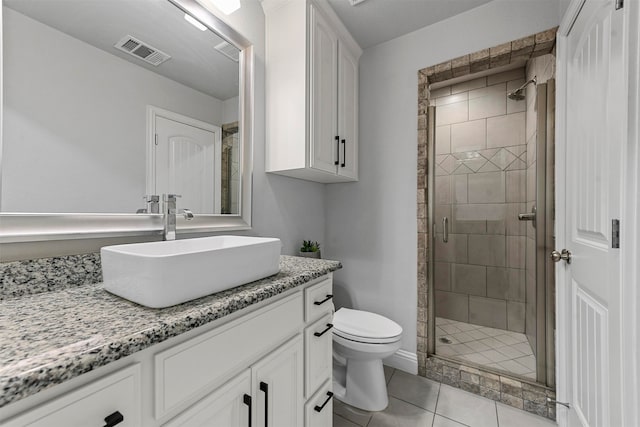 bathroom with walk in shower, tile patterned floors, vanity, and toilet