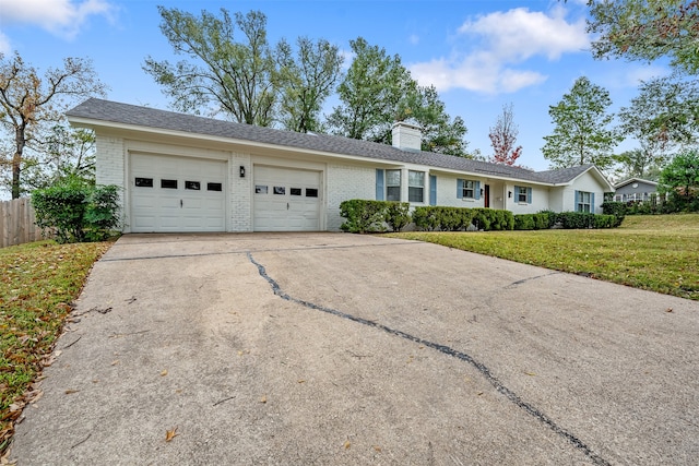 ranch-style house featuring a front lawn and a garage