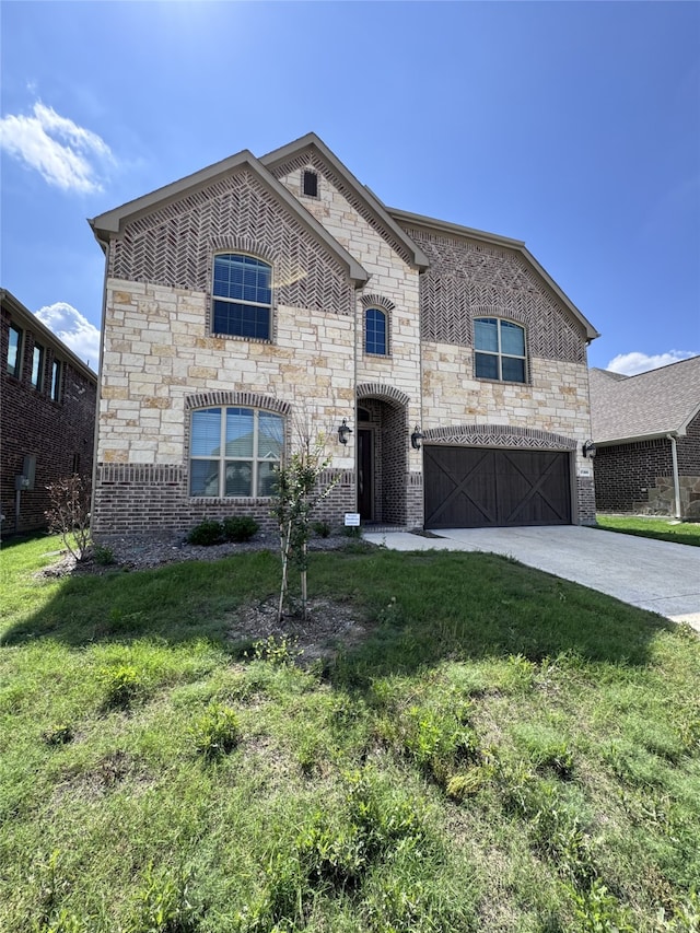 view of front of property featuring a garage and a front yard