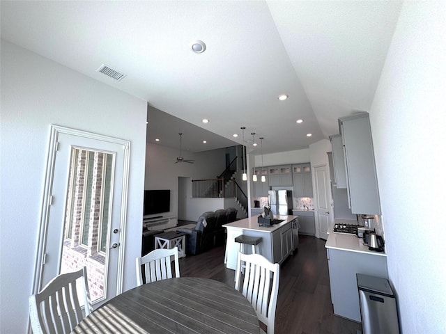 dining area featuring dark hardwood / wood-style flooring, a wealth of natural light, and ceiling fan