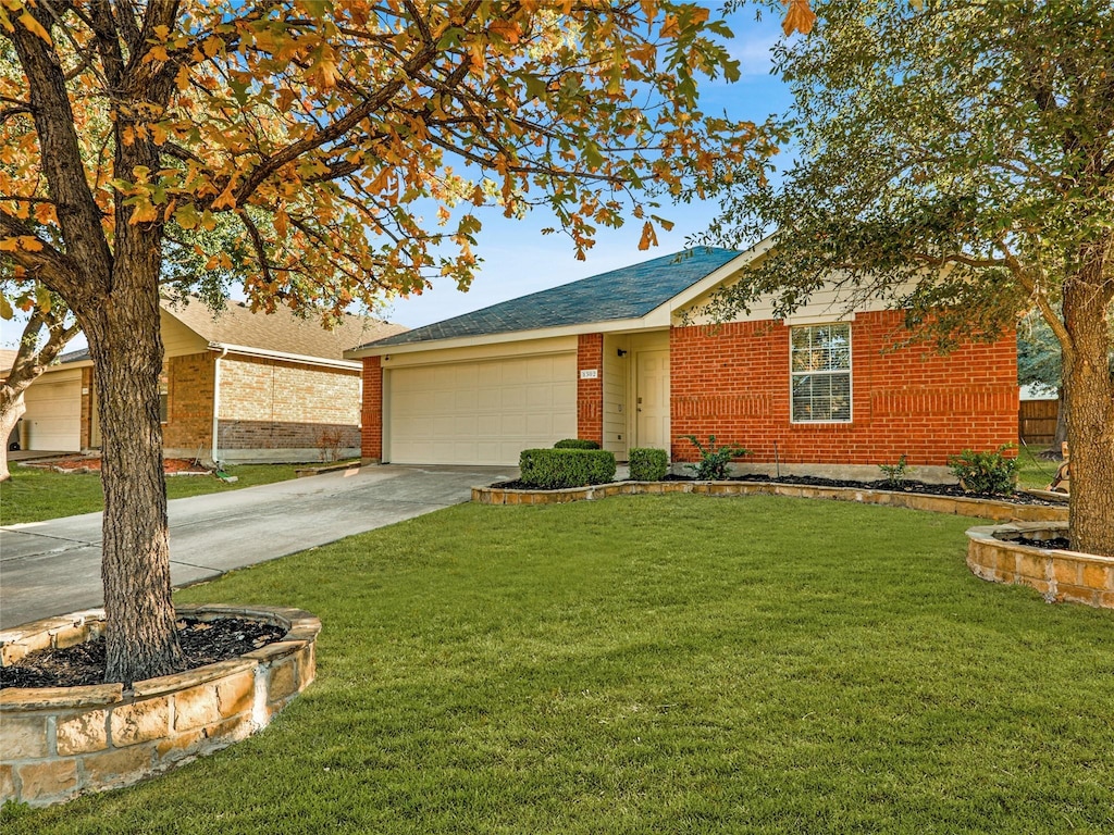 ranch-style house featuring a garage and a front lawn