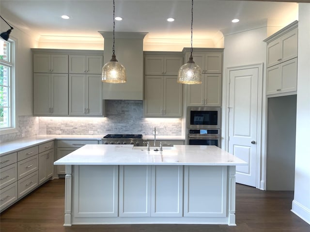 kitchen featuring gray cabinetry, stainless steel appliances, pendant lighting, and a sink