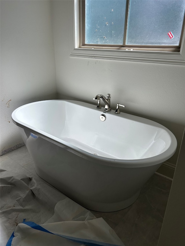 full bath featuring a freestanding tub