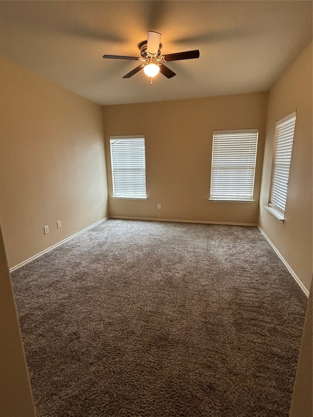 spare room with carpet and ceiling fan