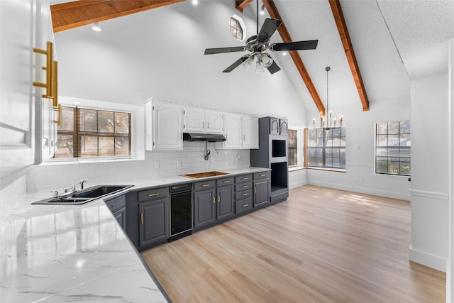 kitchen with beam ceiling, gray cabinets, and white cabinets