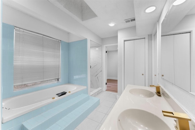 bathroom featuring separate shower and tub, tile patterned flooring, and vanity