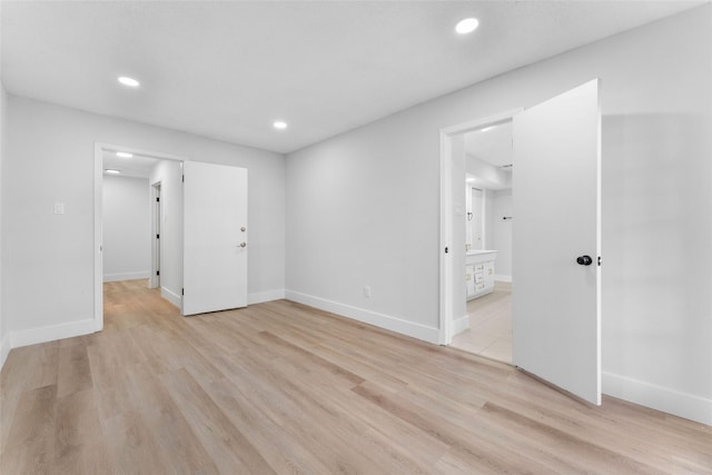 spare room featuring light wood-type flooring