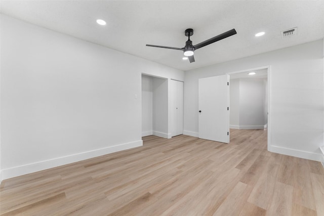 unfurnished bedroom with ceiling fan and light hardwood / wood-style floors