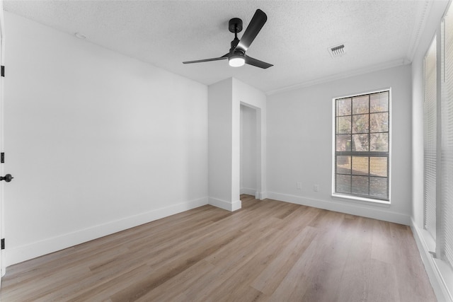 spare room with ceiling fan, light hardwood / wood-style flooring, and a textured ceiling