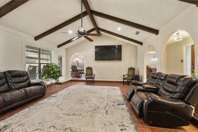 living room with arched walkways, a chandelier, wood finished floors, ceiling fan, and a textured ceiling
