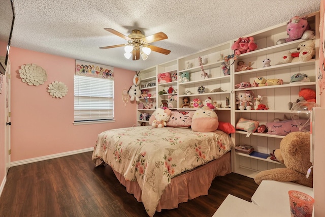 bedroom featuring dark wood-style floors, a textured ceiling, baseboards, and a ceiling fan