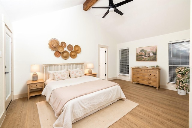 bedroom with ceiling fan, light hardwood / wood-style floors, and lofted ceiling with beams