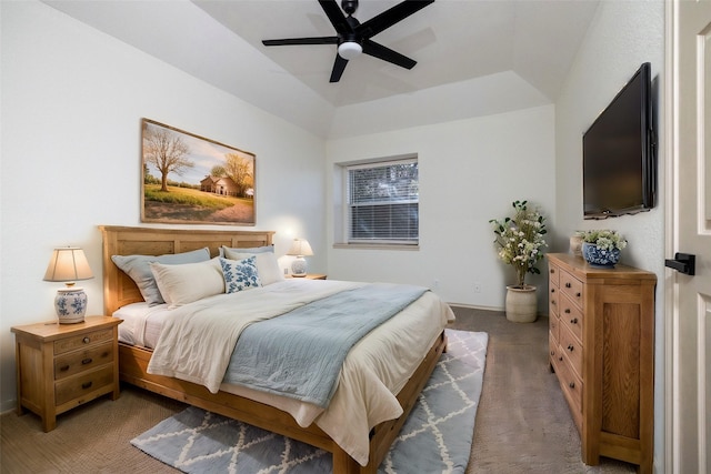 bedroom featuring lofted ceiling, carpet flooring, ceiling fan, and a raised ceiling