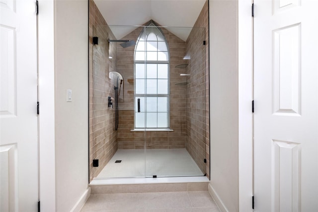 bathroom with a shower with shower door and tile patterned floors