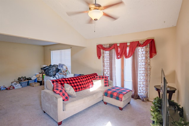 living room featuring ceiling fan, carpet floors, and vaulted ceiling