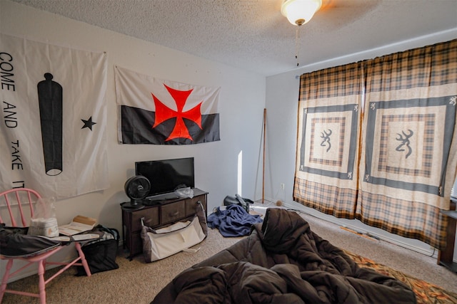 bedroom with carpet flooring, ceiling fan, and a textured ceiling