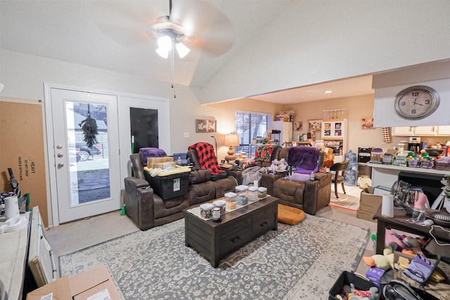 carpeted living room featuring ceiling fan and lofted ceiling