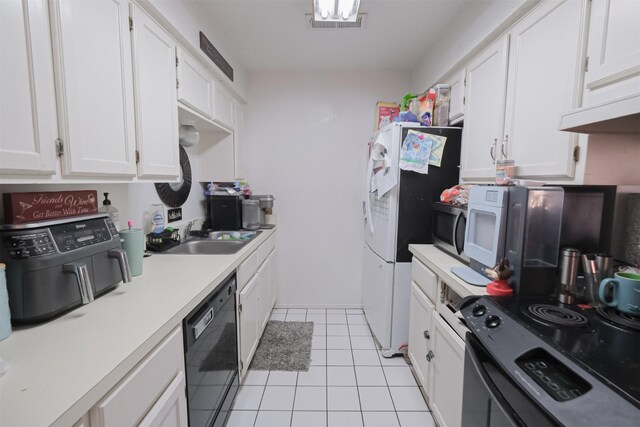 kitchen featuring black appliances, light tile patterned flooring, white cabinets, and sink