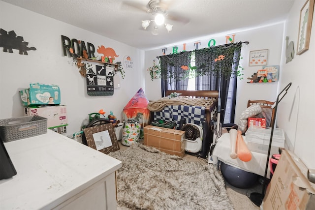 bedroom with carpet, a textured ceiling, and ceiling fan