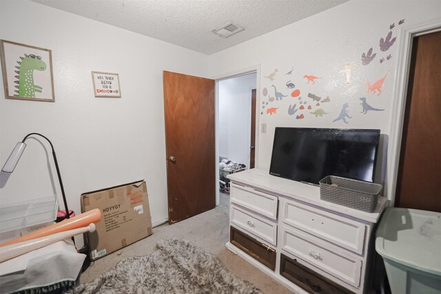 carpeted bedroom featuring a textured ceiling