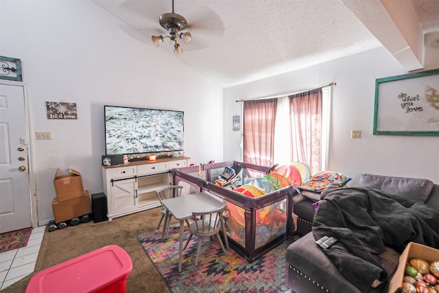 tiled living room featuring a textured ceiling, ceiling fan, and lofted ceiling