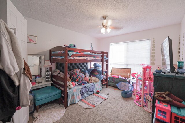 bedroom with carpet flooring, a textured ceiling, and ceiling fan