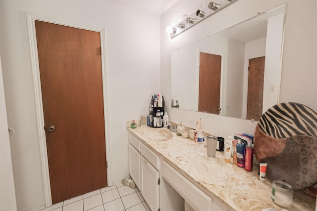 bathroom featuring tile patterned floors, vanity, and a textured ceiling