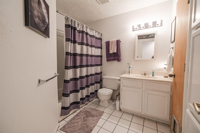 full bathroom featuring vanity, a textured ceiling, shower / bath combo with shower curtain, tile patterned flooring, and toilet