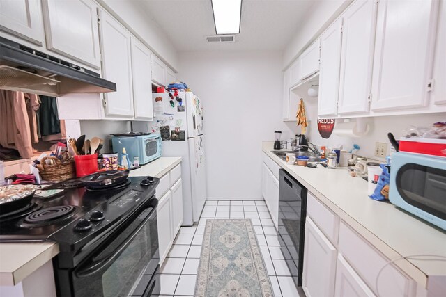 kitchen featuring black appliances, white cabinetry, sink, and light tile patterned floors