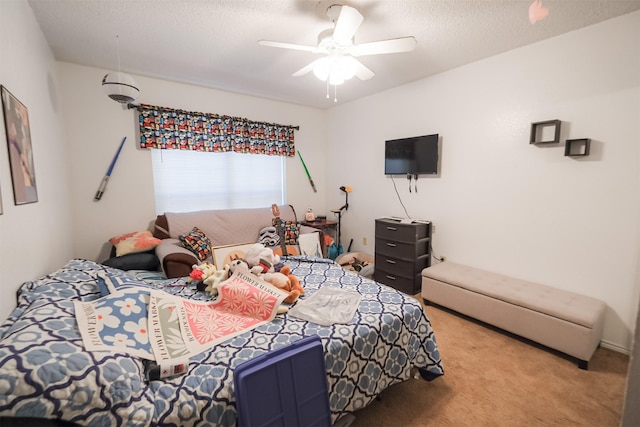 carpeted bedroom with ceiling fan and a textured ceiling