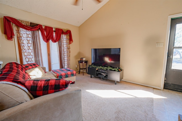 living room with ceiling fan, a healthy amount of sunlight, and vaulted ceiling