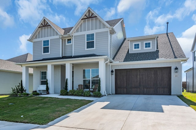 view of front facade featuring a front lawn, a porch, and a garage