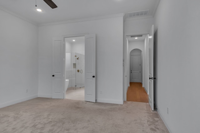 unfurnished bedroom featuring crown molding, ceiling fan, and light carpet