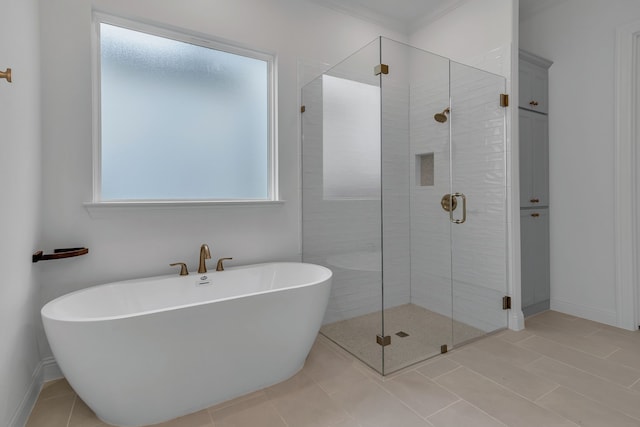 bathroom with tile patterned floors, crown molding, and shower with separate bathtub