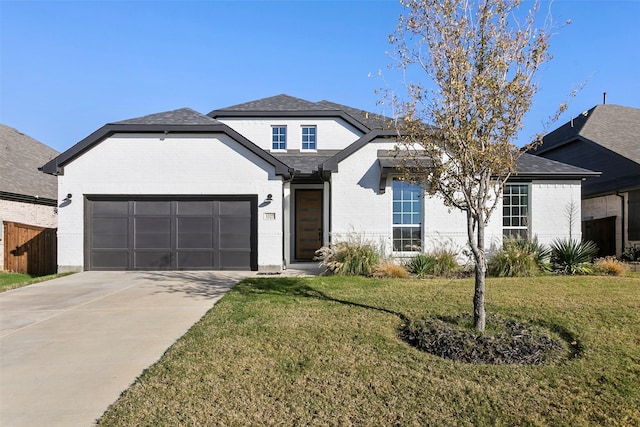 view of front of house with a garage and a front yard