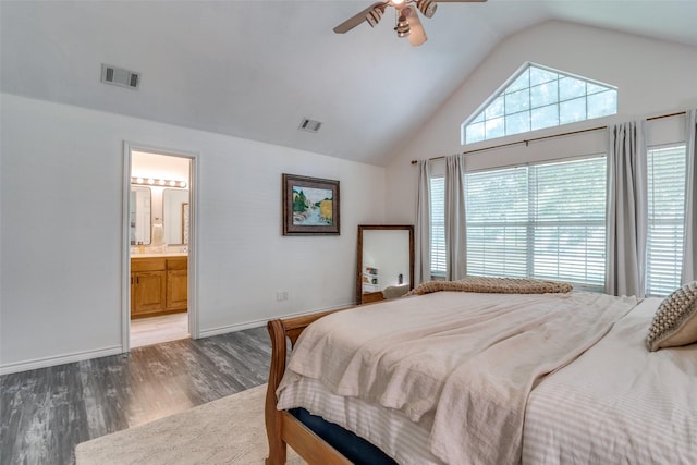 bedroom with dark hardwood / wood-style flooring, lofted ceiling, connected bathroom, and ceiling fan