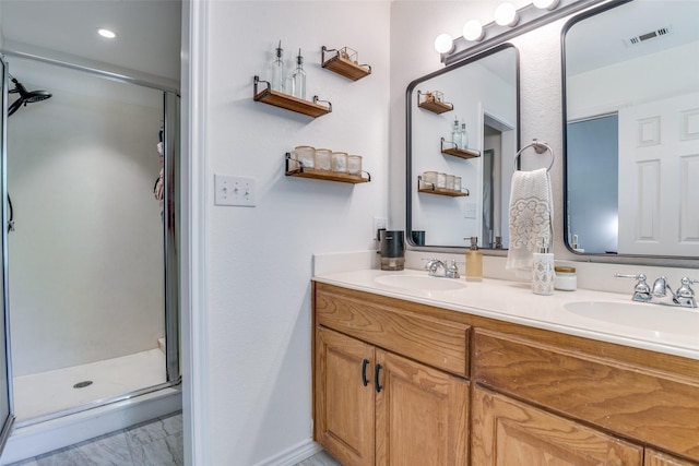 bathroom with vanity and a shower with shower door