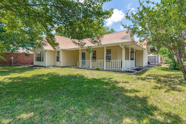 back of property with a porch and a yard