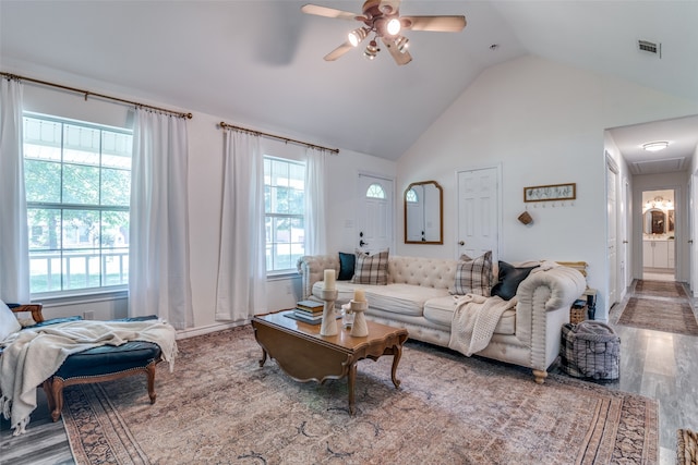 living room with hardwood / wood-style floors, vaulted ceiling, and ceiling fan